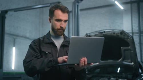 Adult Man Caucasian Male Auto Mechanic Repairman Using Laptop Checking Car Engine Computer