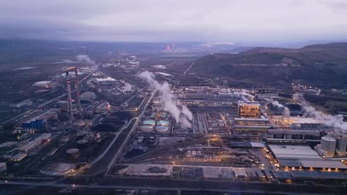 View of a Heavily Smoking Factory at Night Industrial Area Aerial View