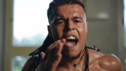 Slow Motion Closeup of the Face of a Mixed Race Man Actively Running on a Treadmill in the Gym with