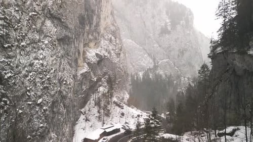 SnowCovered Mountain Road in a Dramatic and Picturesque Winter Landscape Setting