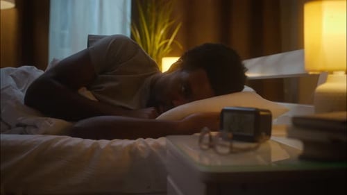 Irritated Disturbed Ethnic African American Man Male Guy Sleeping Lying Down Bed Napping Waking