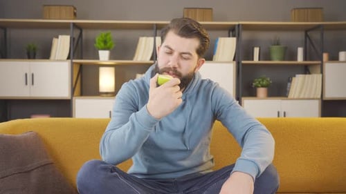 Man eating green apple, diet, health.