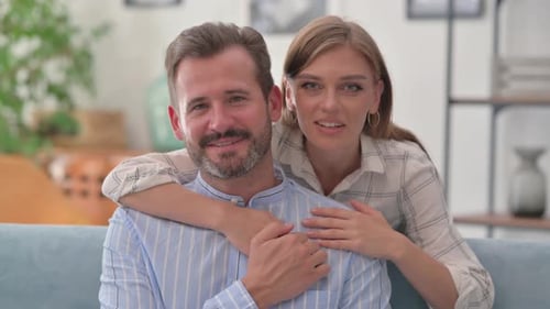 Webcam View of Hugging Young Couple Doing Video Chat at Home