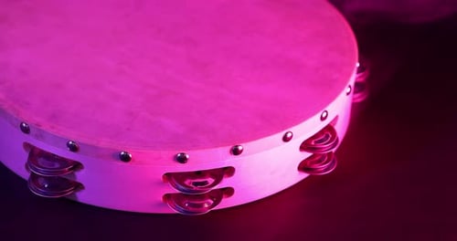 Tambourine Percussion Instrument Close Up with Pink Lighting