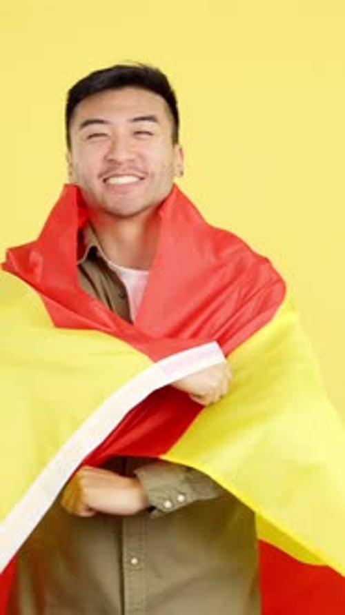 Smiling Man Wrapped in Spanish Flag