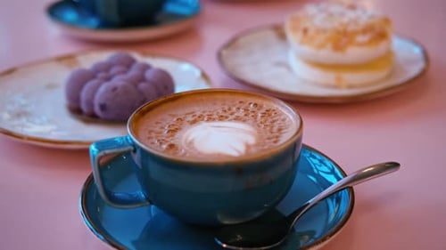 Cup of Cappuccino with Art Milk Foam Top View Latte with Steel Spoon Hot Coffee in a Blue Ceramic