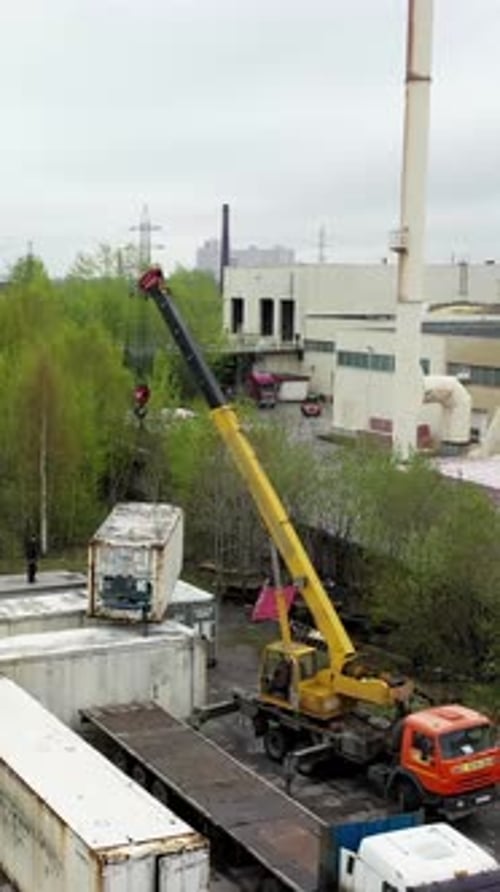 Crane Lifting Container in Urban Factory Area