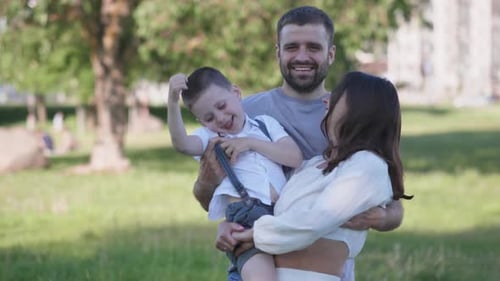Happy Family Posing Together Outdoors on Sunny Day