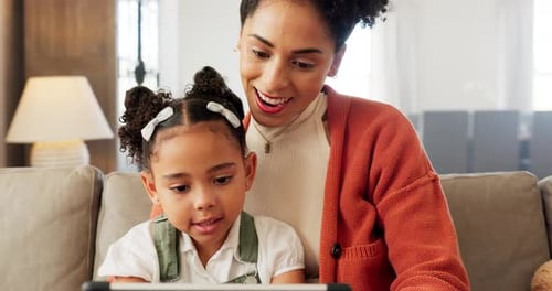 Smiling Woman and Child Using Tablet at Home