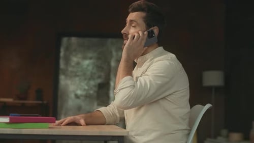 Man Talking on Phone at Office Desk