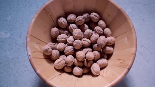 Walnuts Falling into a Bowl