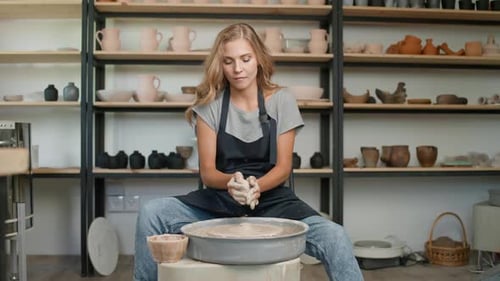 Handicraft Pottery Workshop Portrait of Pretty Woman Ceramist at Work Potter Makes a Pitcher Out of