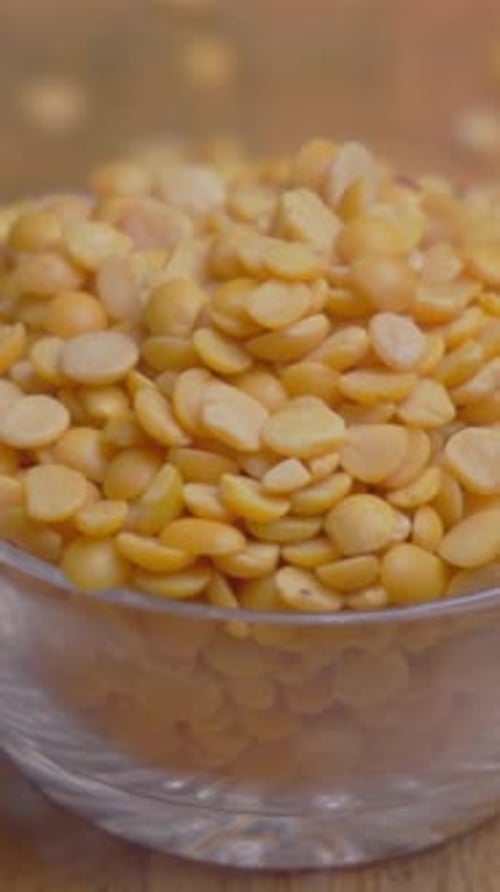 Yellow Split Peas in Glass Bowl Rotating Close Up