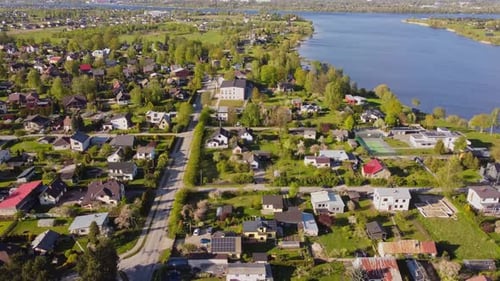 Katlakalns residential area, Daugava river shoreline, colorful houses and tree lines in springtime