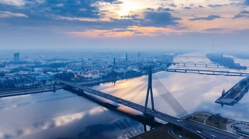 Epic Hyperlapse of Foggy Riga Sunrise With Vanšu Bridge and Daugava Reflections