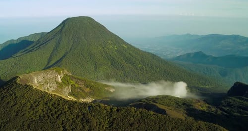 Aerial View of Tropical Mountain Landscape with Sunset Glow and Fog Indonesia