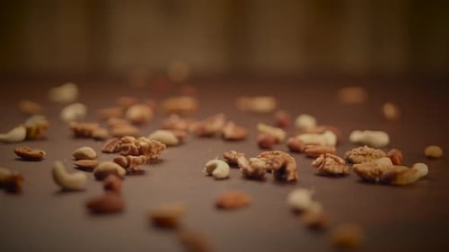 Assorted Nuts Scattered on Brown Surface