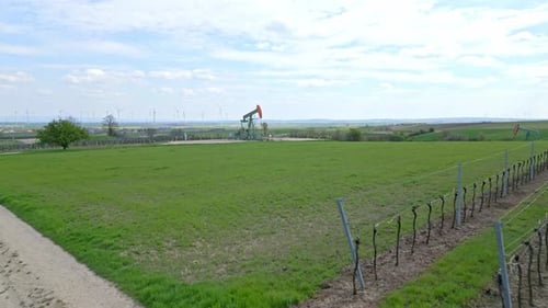 Oil Field With Working Pump Jack In Zistersdorf, Austria - drone forward