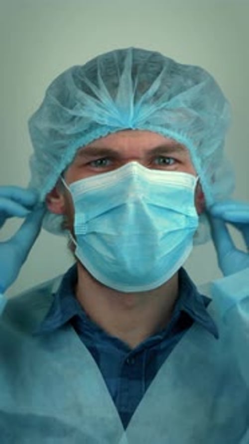 Man Putting on a Surgical Mask, Close-Up