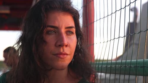 Woman Contemplates City at Sunset