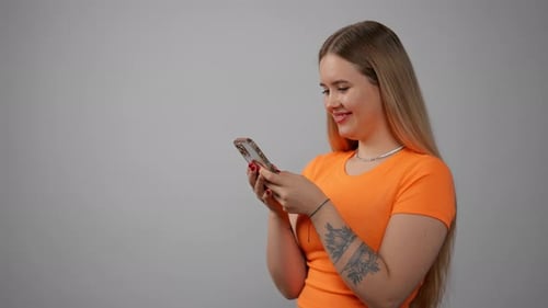 Young Woman Using Smartphone in Studio Setting