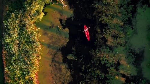 Active female kayaking in river at summer.