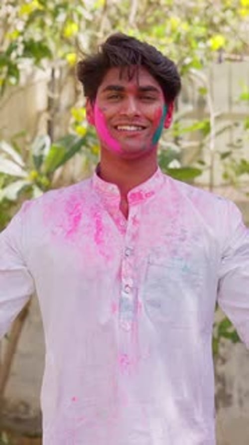 Smiling Man Covered in Holi Powder Celebrates
