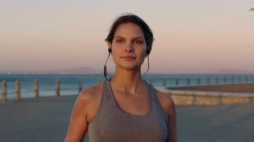 Woman, beach running and headphones of a runner with music doing sports, fitness and workout