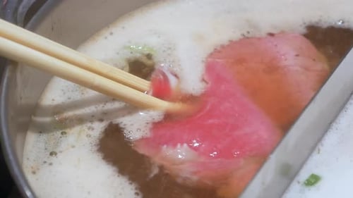 Boiling water in hotpot soup.Shot in 4K. Delicious home cooking in hotpot style Japanese shabu-shabu