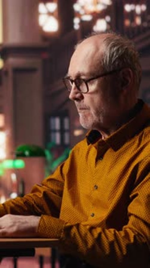 Vertical Video Elderly Man Highlighting Important Ideas From Coursework Papers