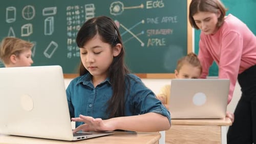 Smart asian girl looking at camera while coding engineering prompt. Pedagogy.