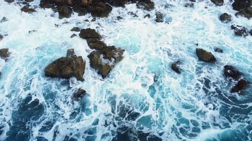 Flying Over Ocean Coastline Cliffside with Blue Pure Water Sea Waves Washes the Rocky Shore Above