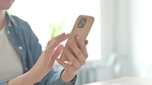 Close Up of Female Browsing Internet on Smartphone