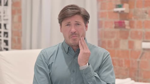 Portrait of Mature Adult Man with Toothache
