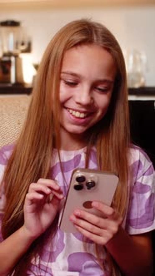 Girl Uses Smartphone in Living Room at Home