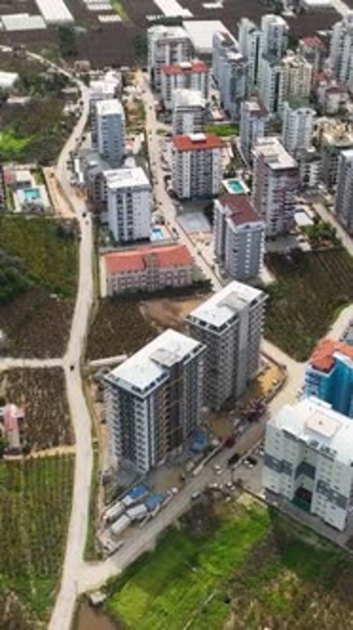 Vertical Video Above the Towering Project Aerial View of MultiStory Building Construction Site