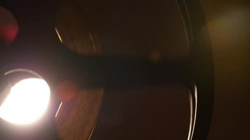 Rotating Vintage Film Reel in Dark Background