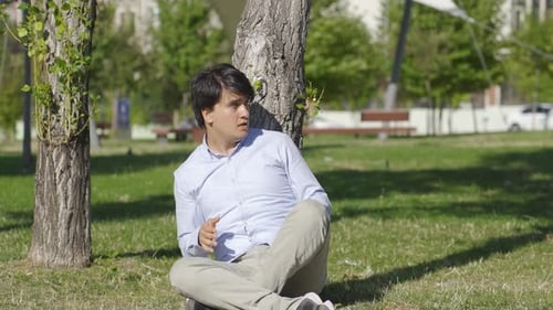 Troubled young man looks around scared.
