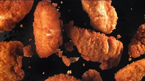 Golden Fried Chicken Pieces on Dark Background