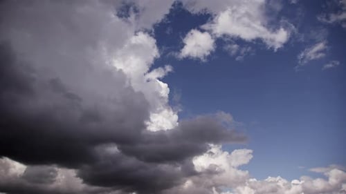 Fluffy Clouds Drifting Through Blue Skies