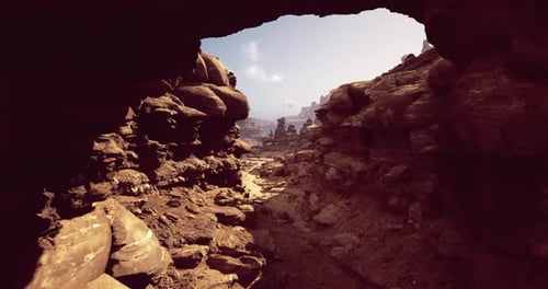 Scenic View Through a Rocky Arch in a Desert Landscape During Daytime
