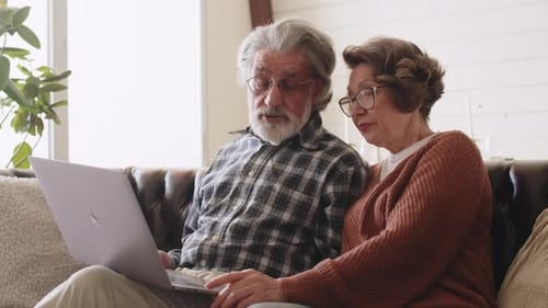 Senior Couple Uses Laptop Together at Home