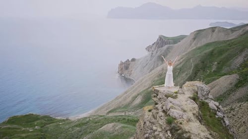 Woman in White Dress Practice Yoga on Cliff Edge