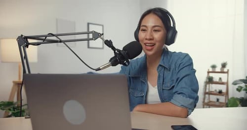 Young adult at home recording podcast