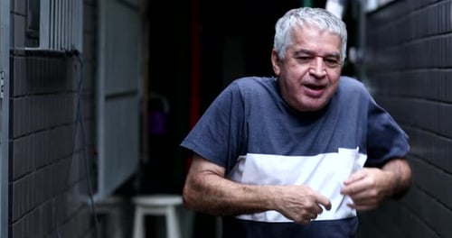Old man celebrating success dancing funny funky dance
