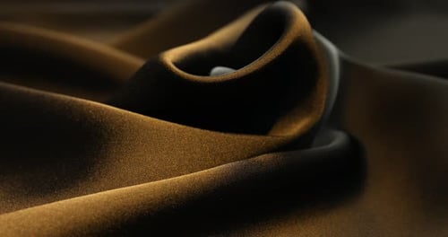 Golden luxurious fabric with elegant folds and lighting