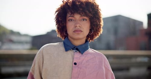 Woman, serious and face with streetwear in city for trendy outfit, style and travel on vacation