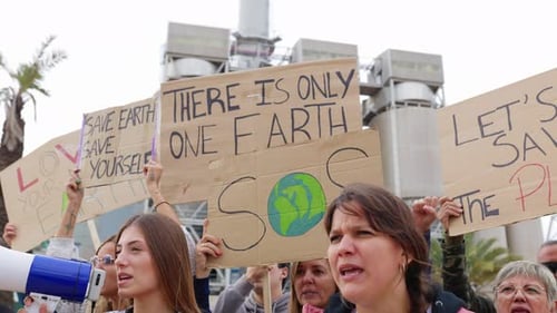 Group of Different People Holding Posters Protesting Against Climate Change