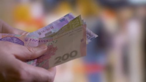 Hand Counting Ukrainian Hryvnia Banknotes Close Up
