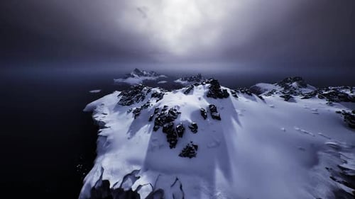 Serene Snowy Coast Aerial Perspective of Icy Promontory and Gentle Water Hues